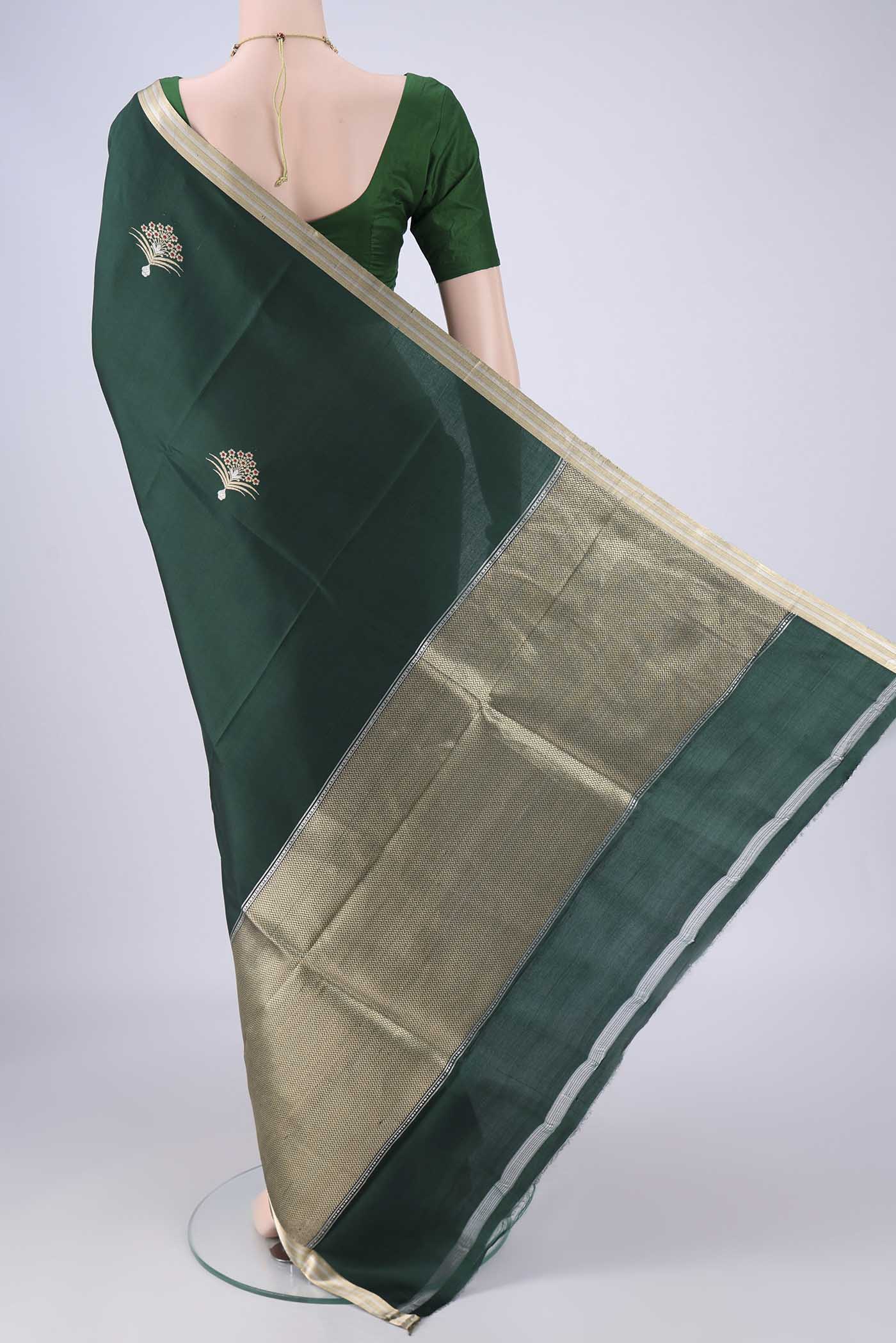 Flat view of Bottle Green Banarasi Silk Saree with Zari Butta on the body and Zari Border. 
