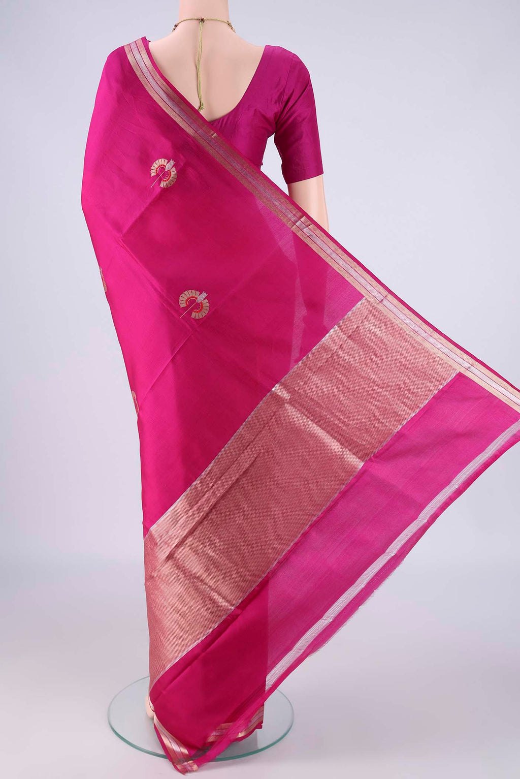 Flat view of Rani Pink Banarasi Silk Saree with Zari And Thread Butta on the body and Zari Border. 