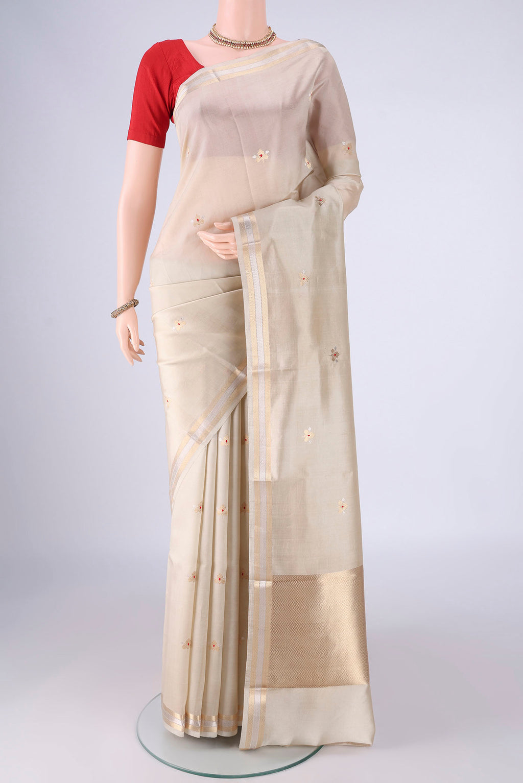 Beige Banarasi Silk Saree with Zari Butta on the body and Zari Border.  displayed on a mannequin