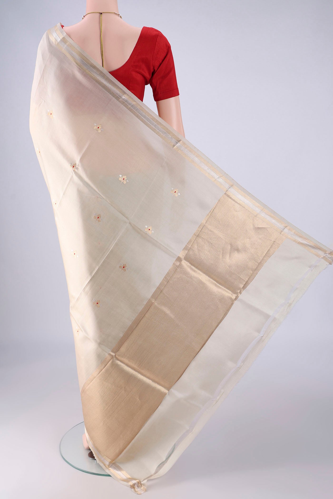 Flat view of Beige Banarasi Silk Saree with Zari Butta on the body and Zari Border. 