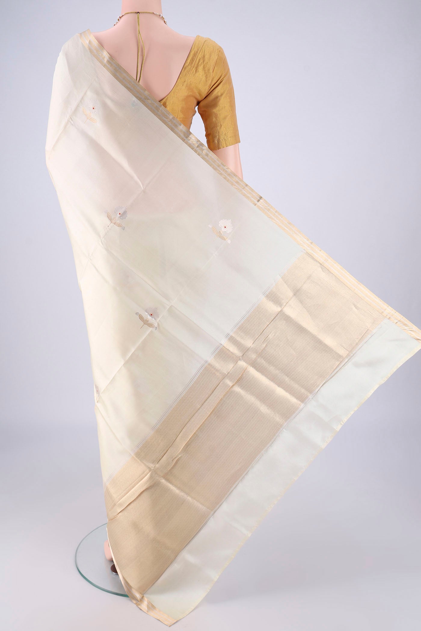 Flat view of Cream Banarasi Silk Saree with Zari Butta on the body and Zari Border. 