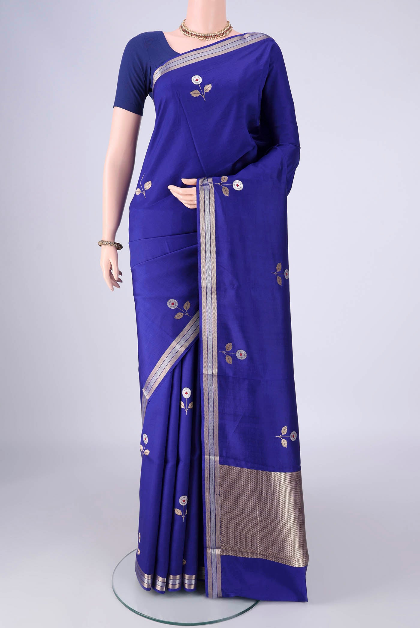 Royal Blue Banarasi Silk Saree with Zari And Thread Butta on the body and Zari Border.  displayed on a mannequin