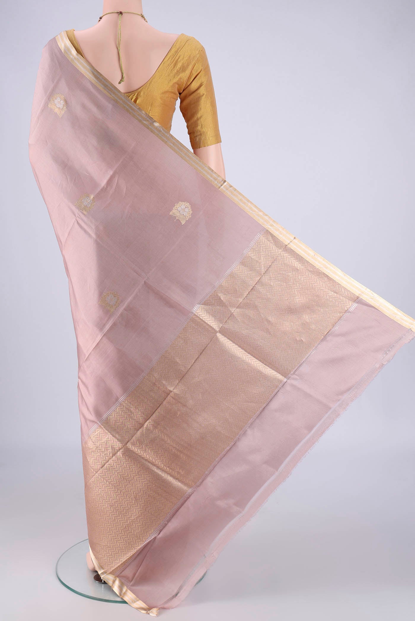 Flat view of Rose Gold Banarasi Silk Saree with Zari Butta on the body and Zari Border. 