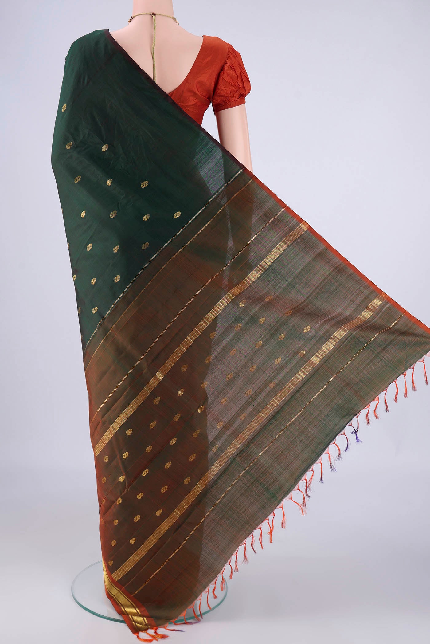 Flat view of Bottle Green Kanchipuram Silk Saree with Zari Butta on the body and One Side Border. 