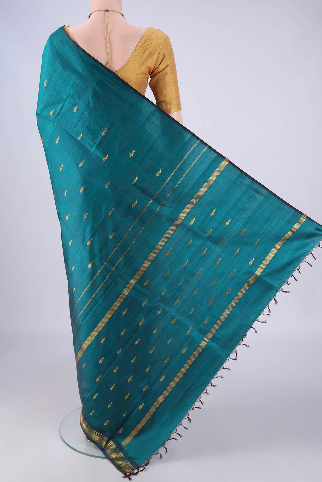 Flat view of Green Kanchipuram Silk Saree with Zari Butta on the body and One Side Border. 