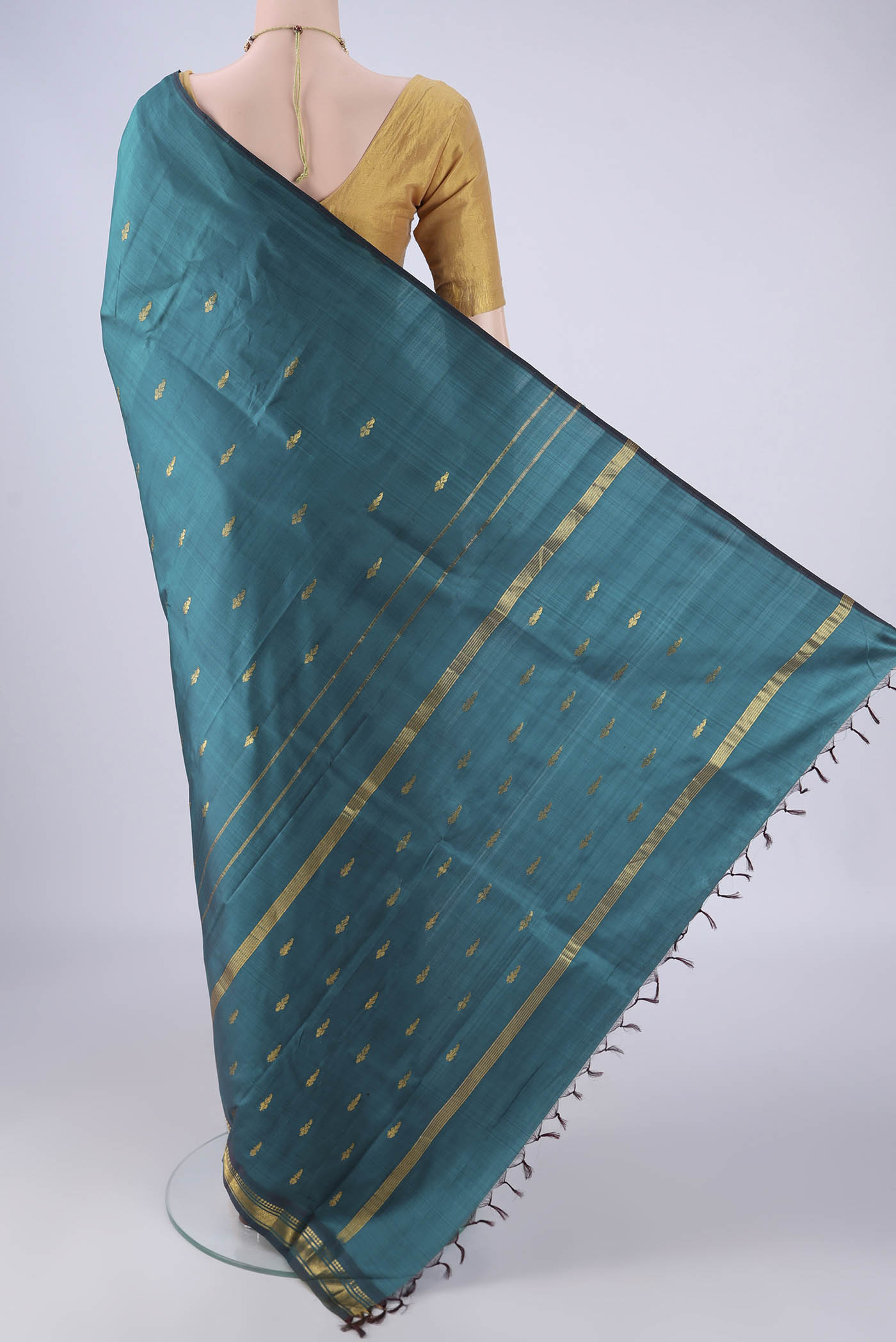 Flat view of Green Kanchipuram Silk Saree with Zari Butta on the body and One Side Border. 