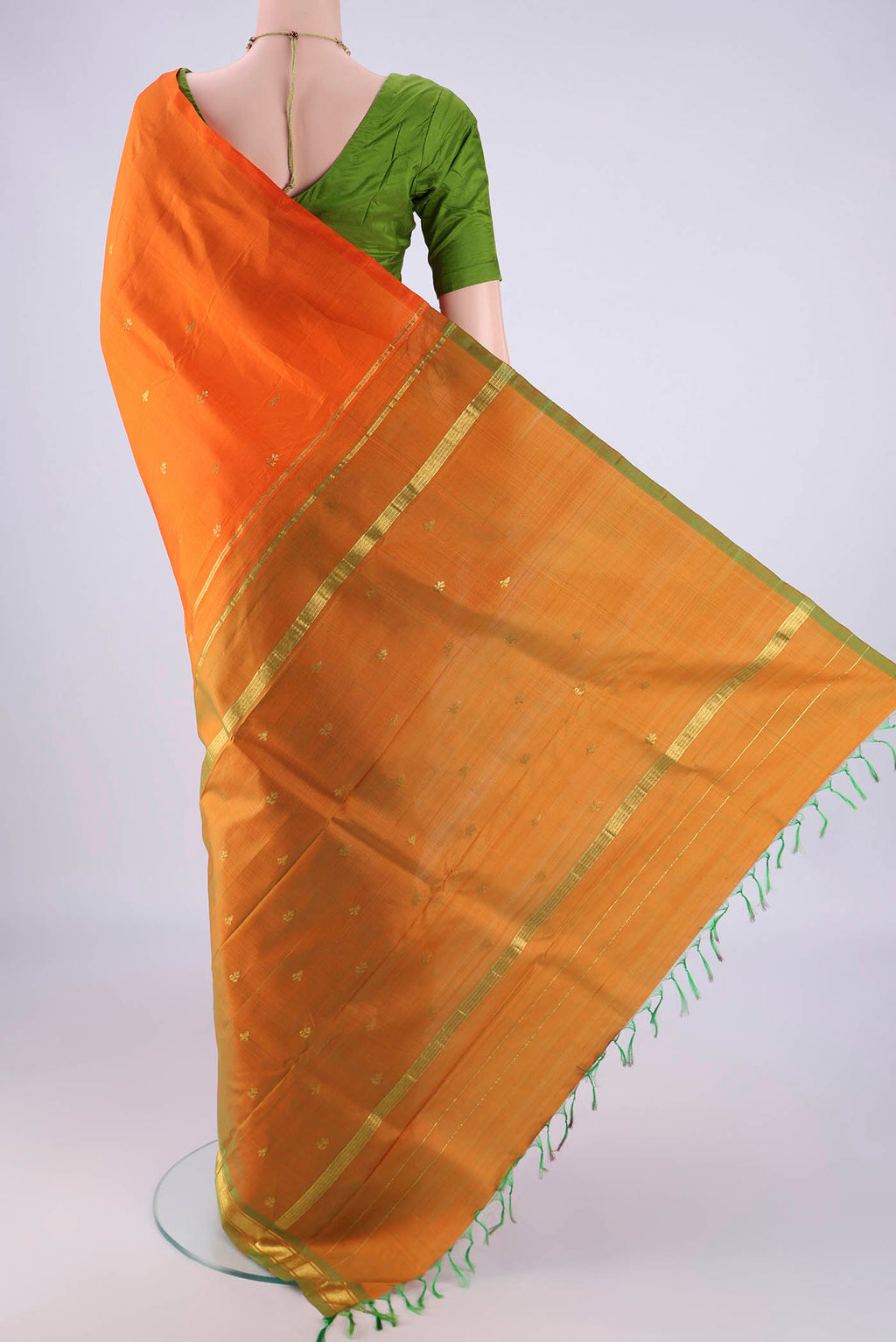 Flat view of Orange Kanchipuram Silk Saree with Zari Butta on the body and One Side Border. 