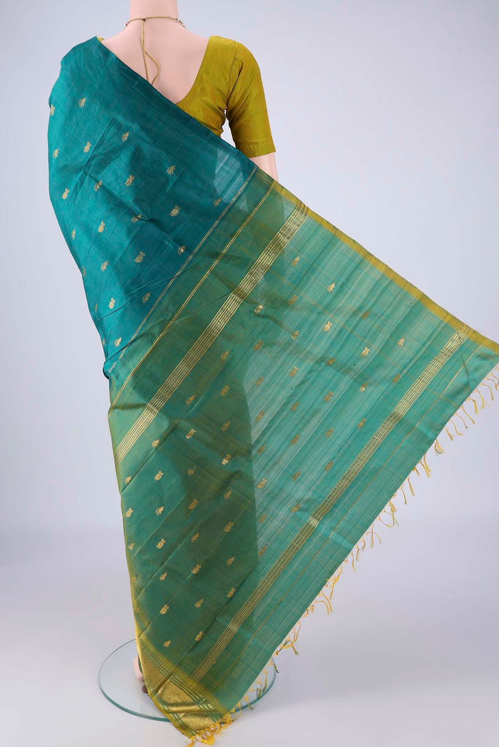 Flat view of Peacock Blue Kanjivaram Silk Saree with Zari Butta on the body and One Side Border. 