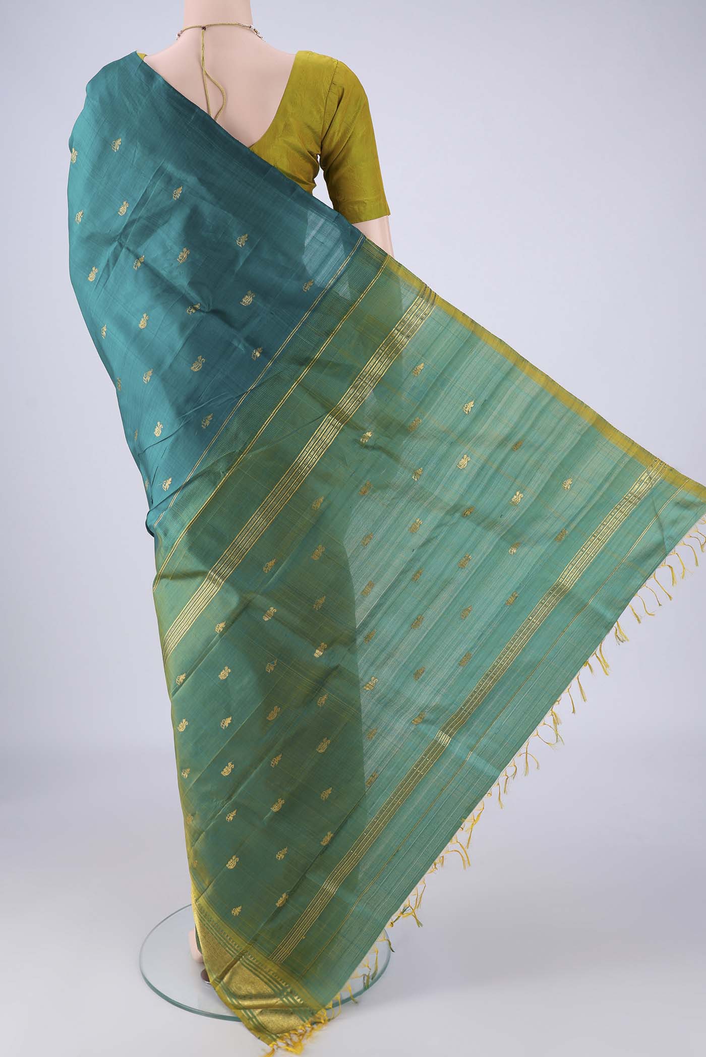 Flat view of Peacock Blue Kanjivaram Silk Saree with Zari Butta on the body and One Side Border. 