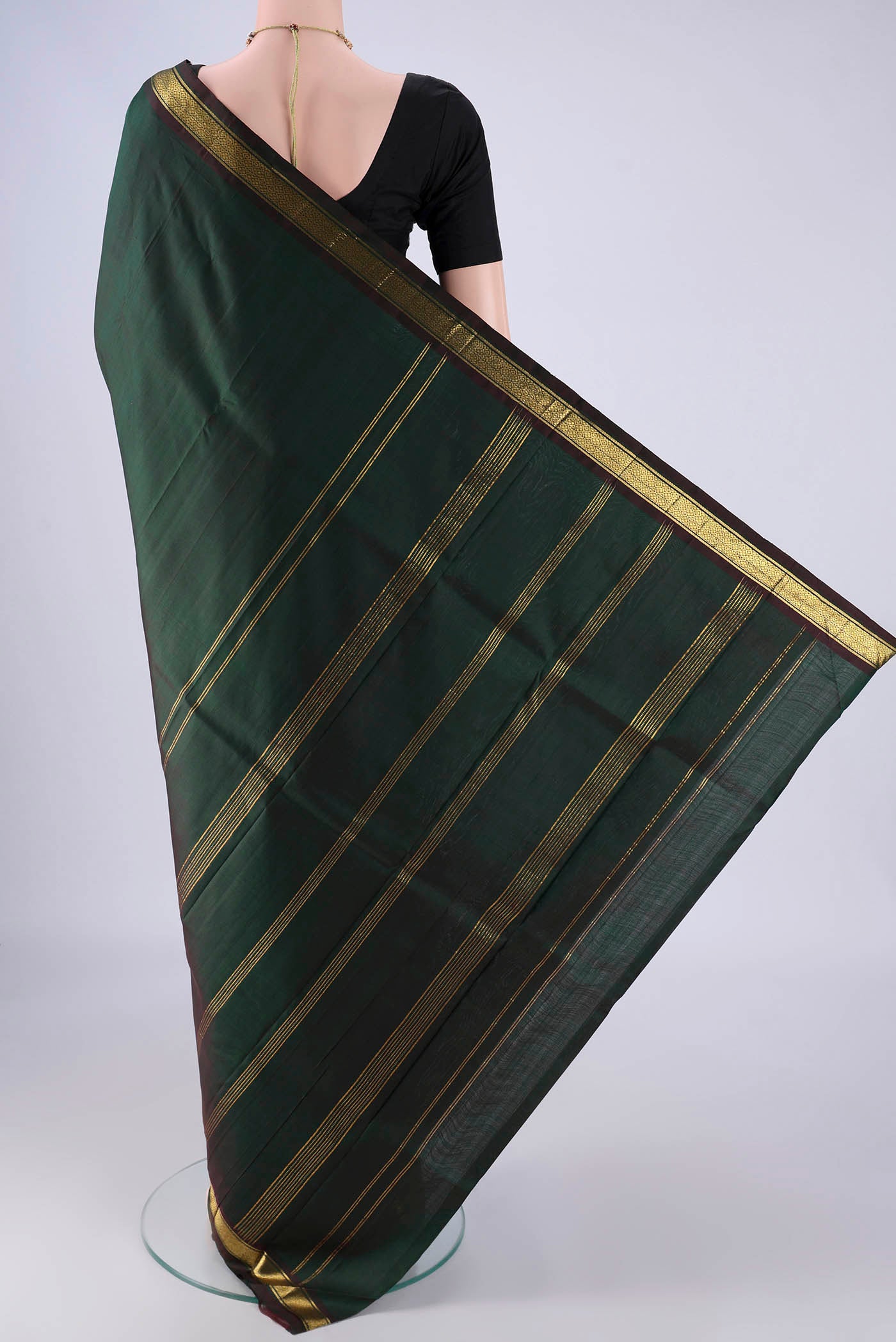 Flat view of Bottle Green Kanjivaram Silk Saree with Plain Body and Zari Border. 
