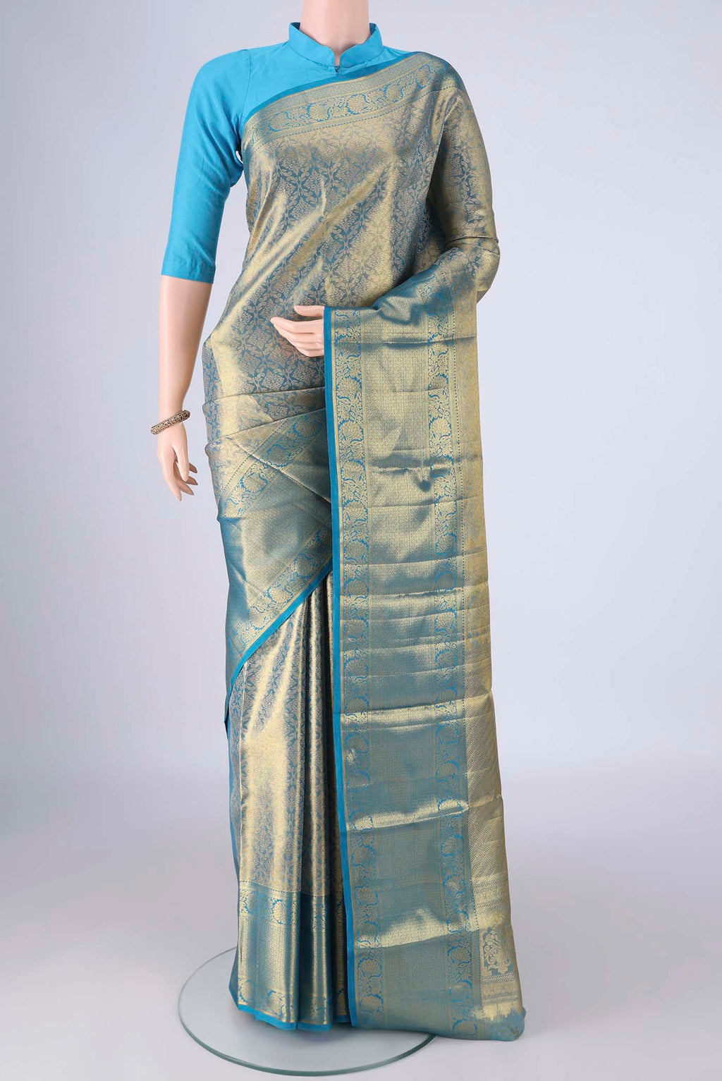 Gold with Blue Color Kanchipuram Tissue Silk Saree with Zari Brocade on the body and Zari Border.  displayed on a mannequin