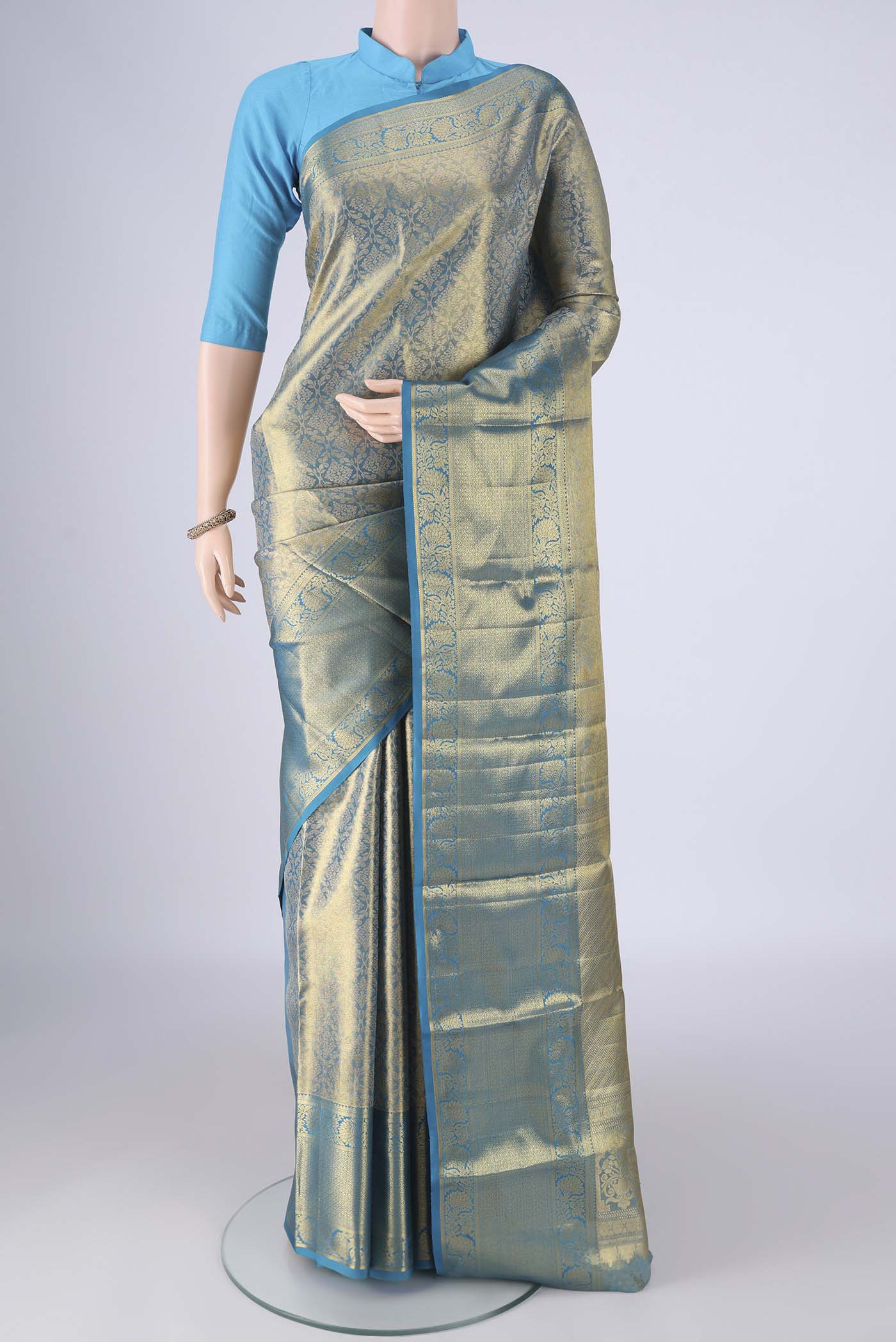 Gold with Blue Color Kanchipuram Tissue Silk Saree with Zari Brocade on the body and Zari Border.  displayed on a mannequin