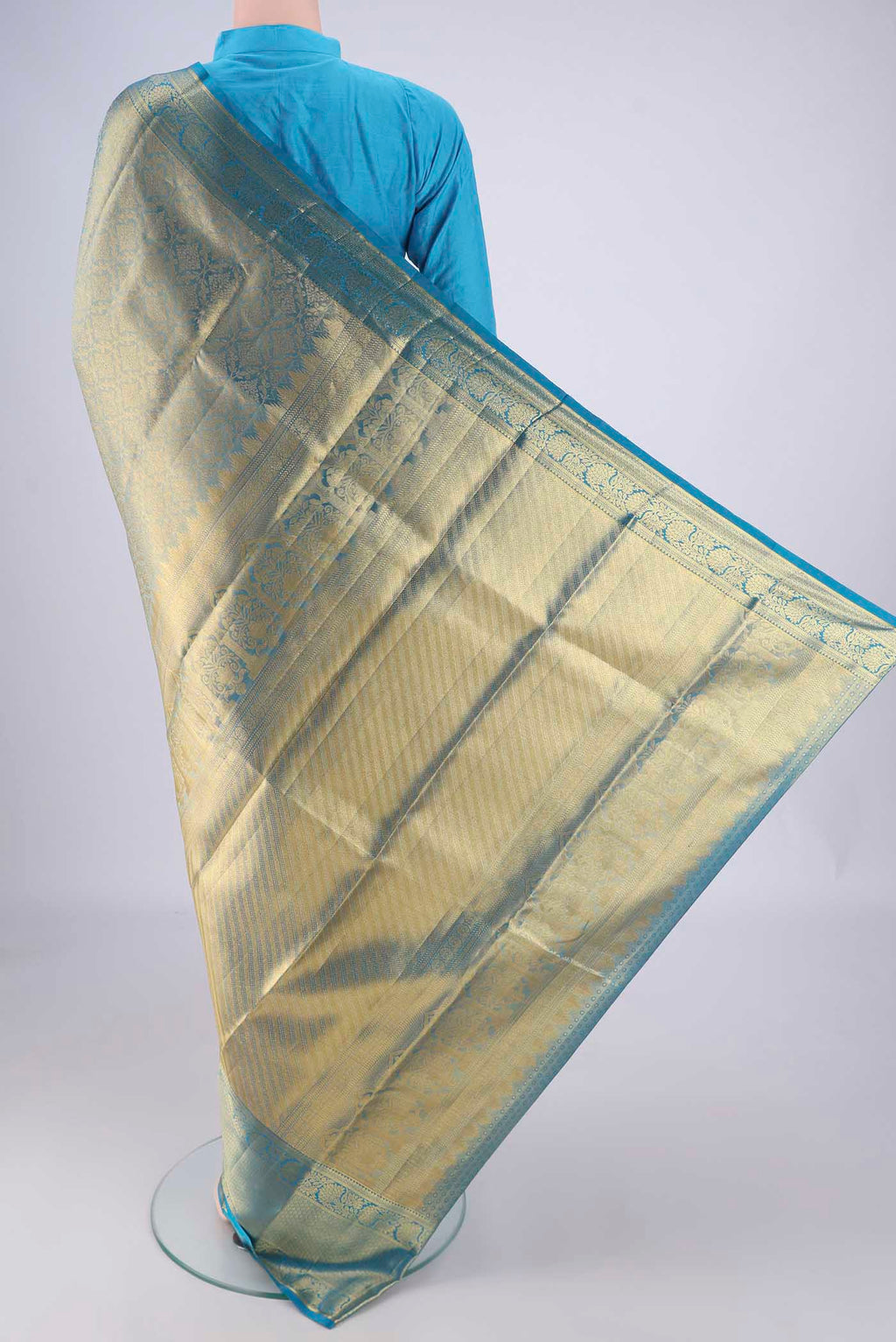 Flat view of Gold with Blue Color Kanchipuram Tissue Silk Saree with Zari Brocade on the body and Zari Border. 