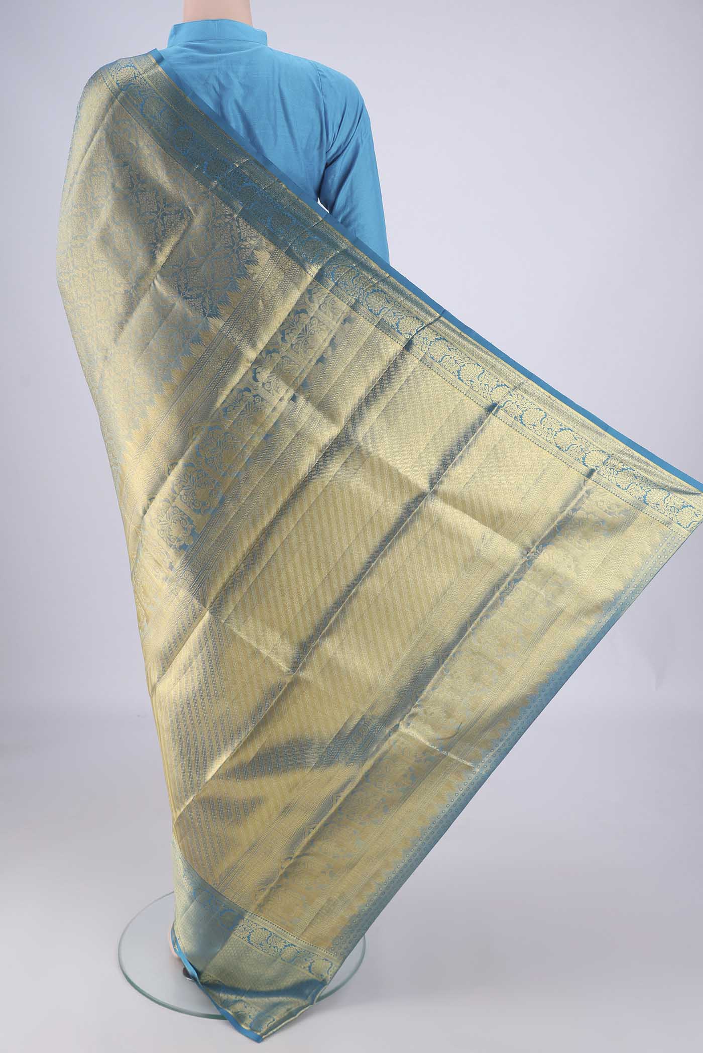 Flat view of Gold with Blue Color Kanchipuram Tissue Silk Saree with Zari Brocade on the body and Zari Border. 
