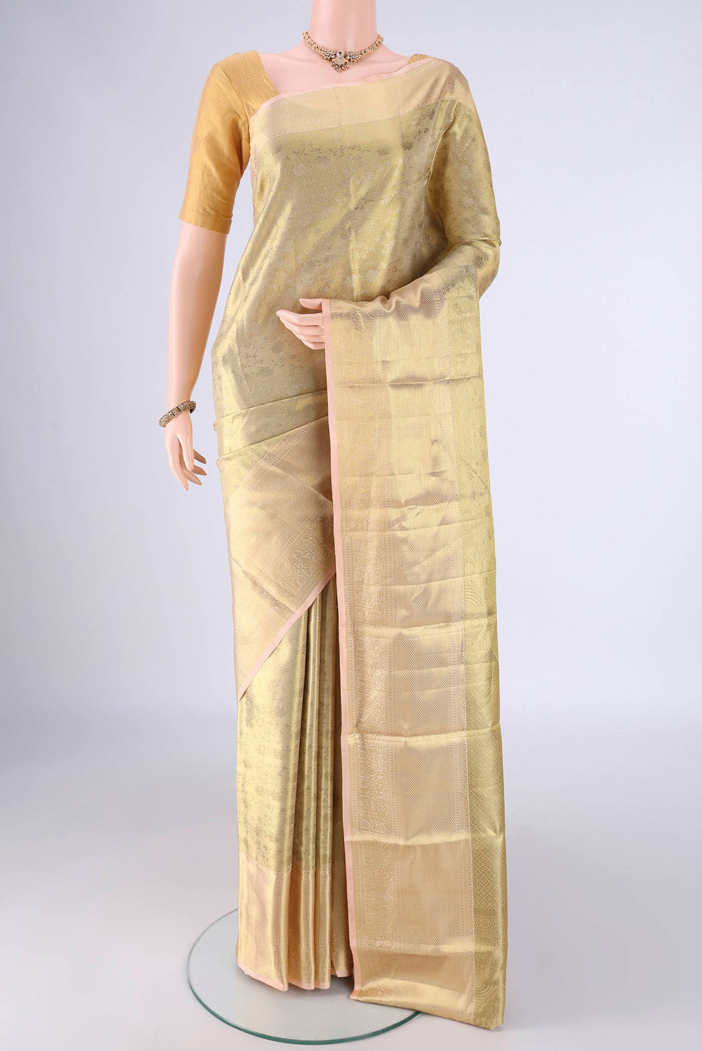 Golden Dual Tone Kanchipuram Tissue Silk Saree with Zari Brocade on the body and Zari Border.  displayed on a mannequin