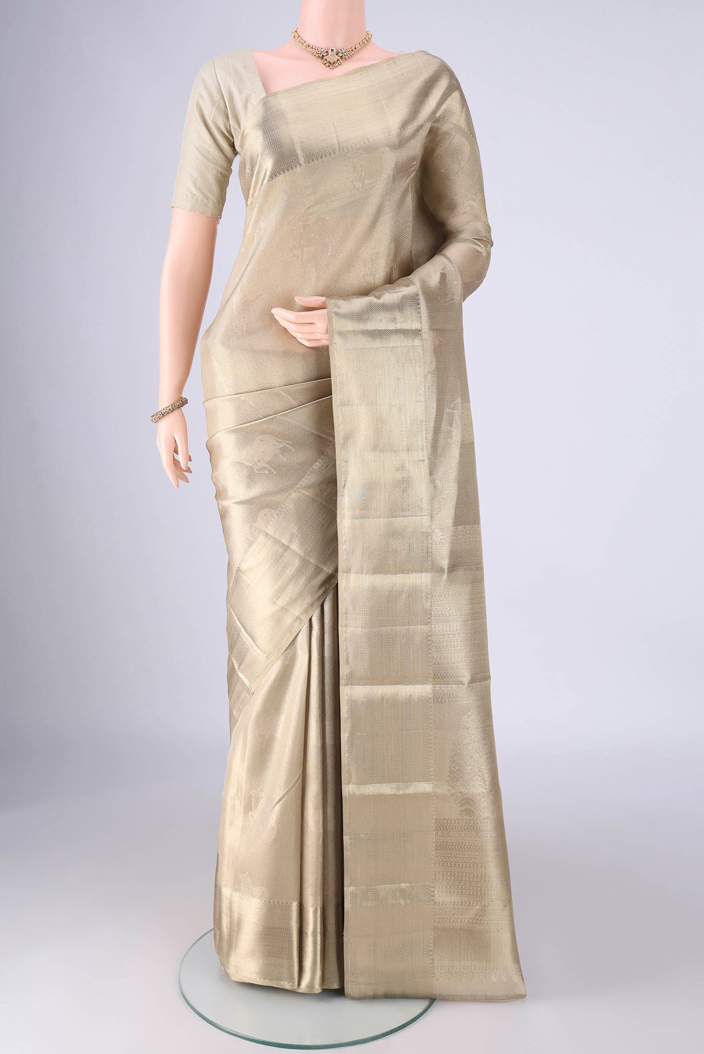 Golden Kanjivaram Tissue Silk Saree with Zari Brocade on the body and Zari Border.  displayed on a mannequin