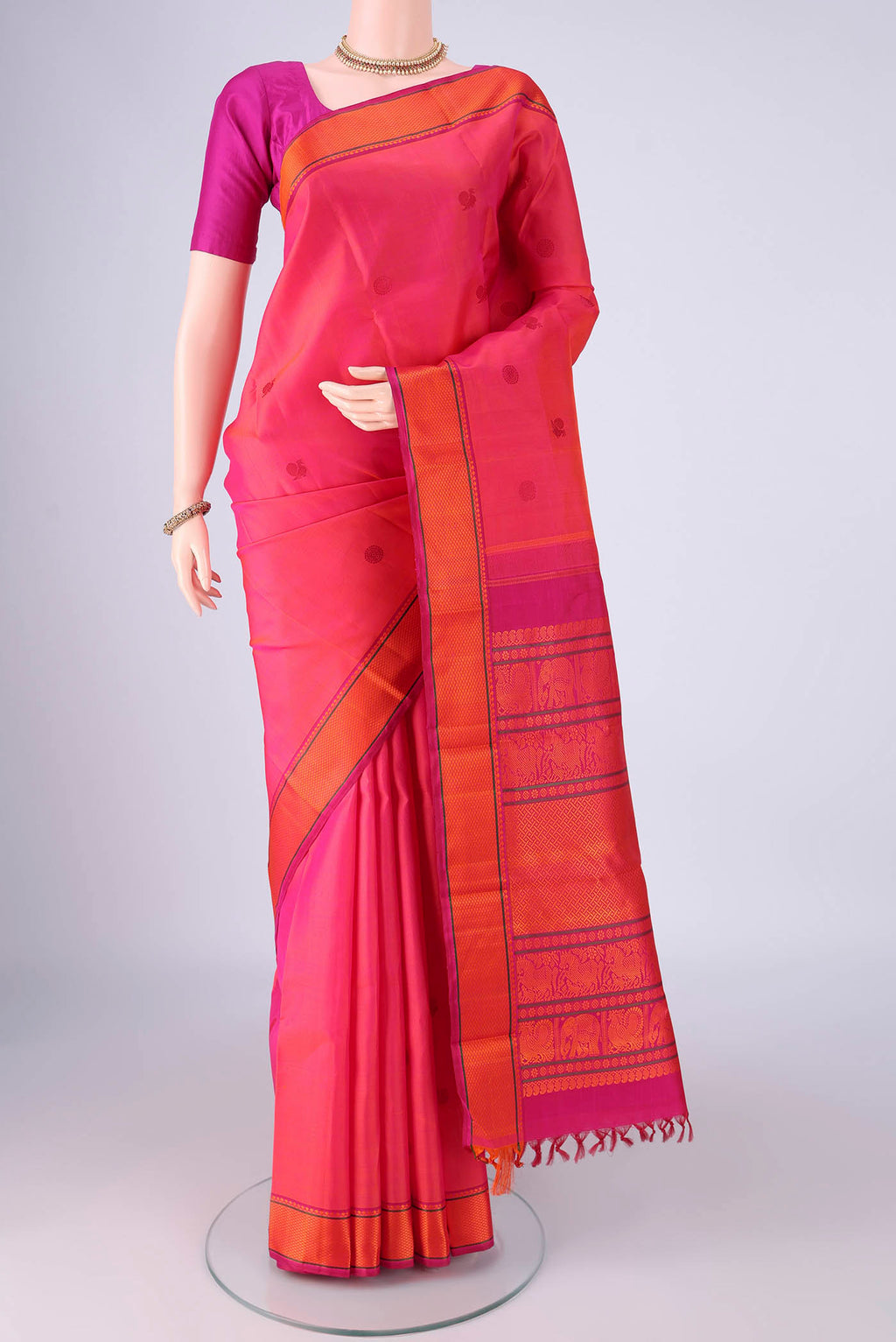 Pink Kanjivaram Silk Saree with Thread Butta on the body and Thread Border.  displayed on a mannequin