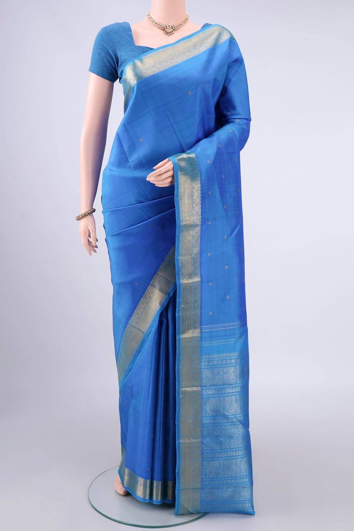 Pure Silk Pure Zari Blue Kanjivaram Saree with Zari Butta on the body and Zari Border.  displayed on a mannequin