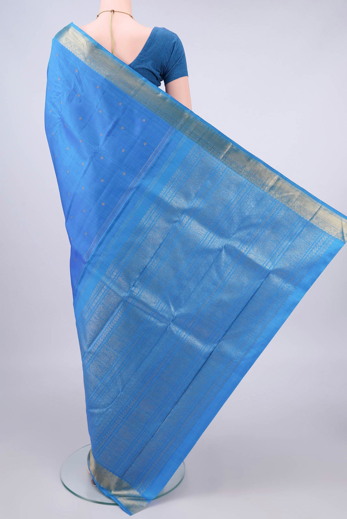 Flat view of Pure Silk Pure Zari Blue Kanjivaram Saree with Zari Butta on the body and Zari Border. 