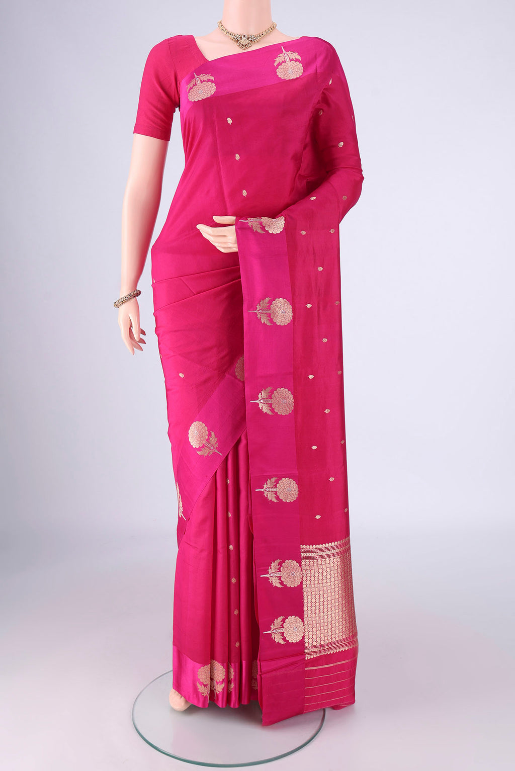 Rani Pink Banarasi Katan Silk Saree with Zari Butta on the body and Fancy Border.  displayed on a mannequin