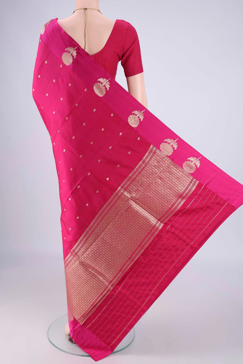Flat view of Rani Pink Banarasi Katan Silk Saree with Zari Butta on the body and Fancy Border. 