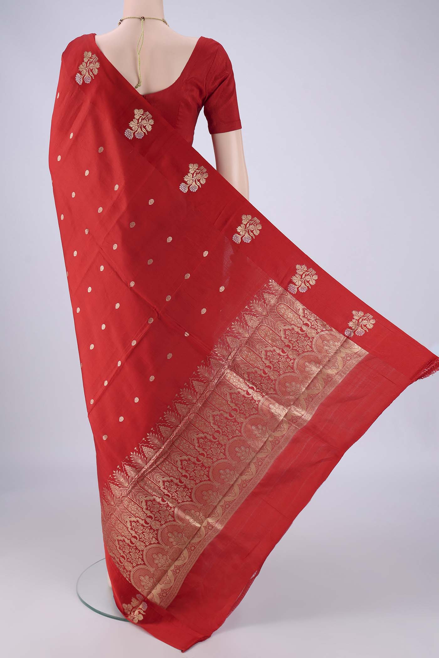 Flat view of Red Banarasi Katan Silk Saree with Zari Butta on the body and Satin Border. 