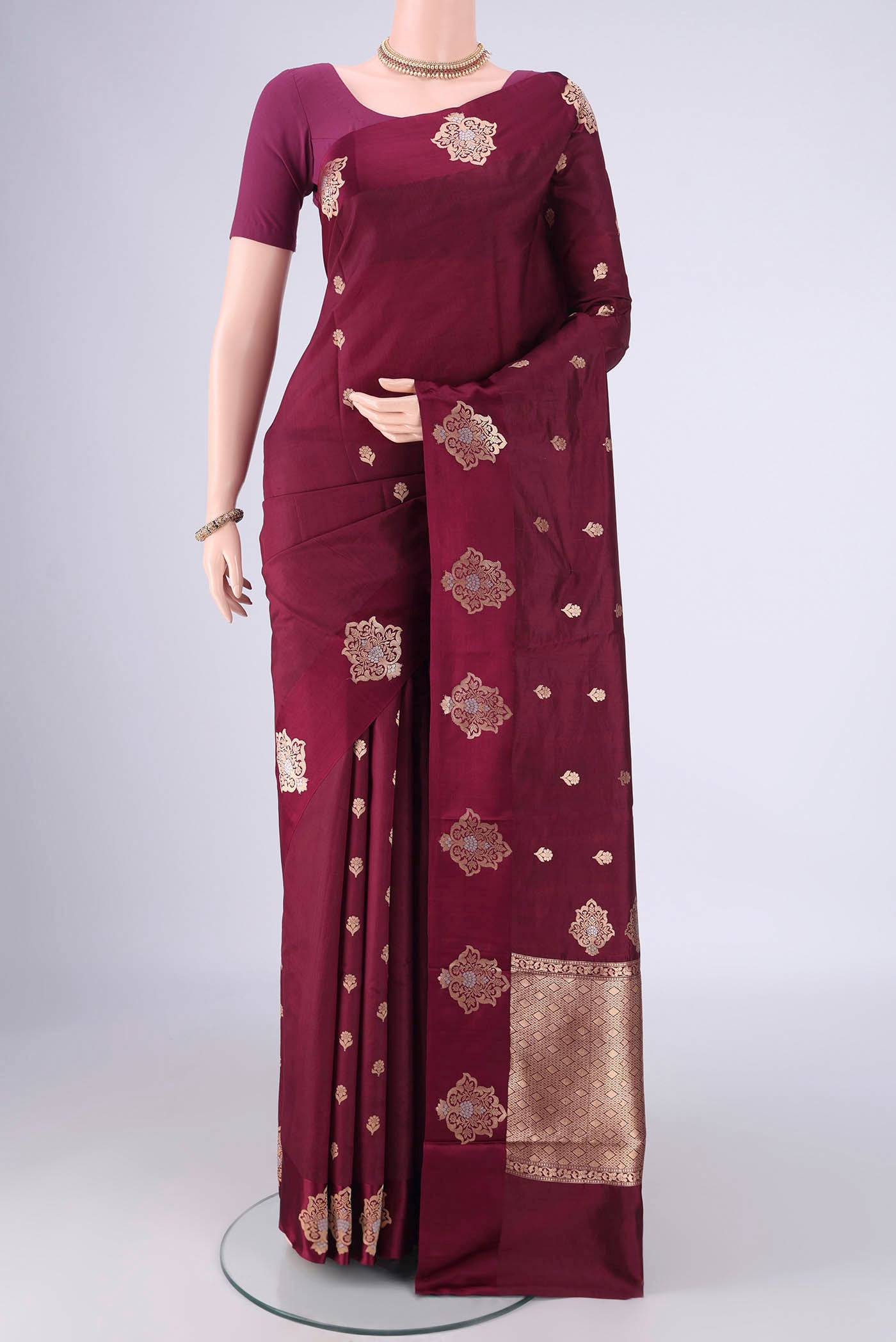 Coffee Brown Banarasi Katan Silk Saree with Zari Butta on the body and Satin Border.  displayed on a mannequin
