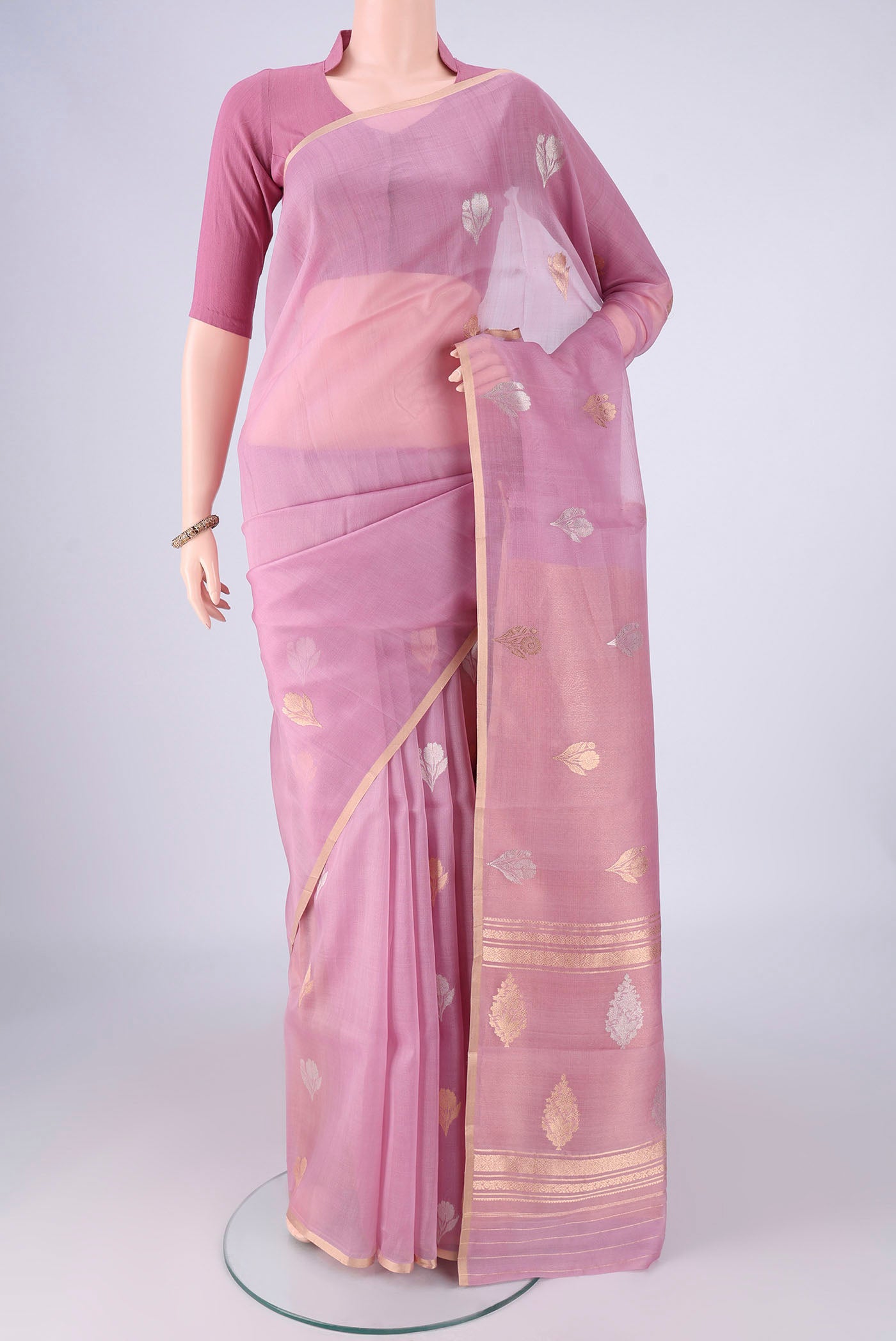 Lavender Organza Silk Saree with Zari Butta on the body and Thin Zari Line.  displayed on a mannequin