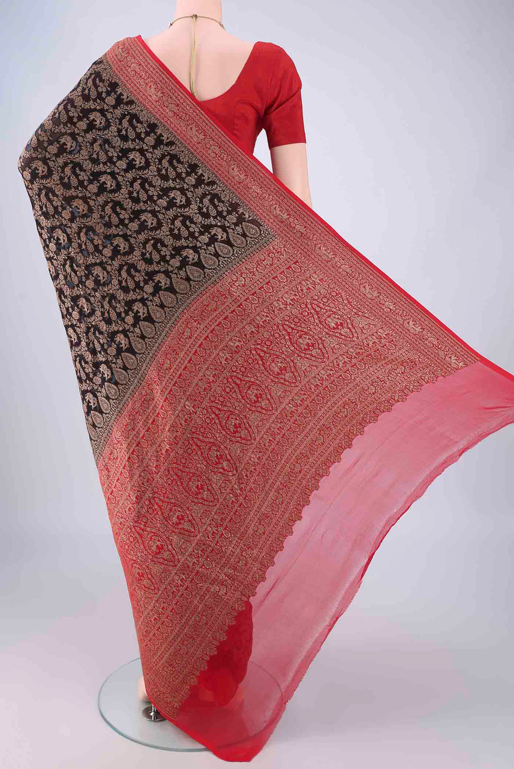 Flat view of Black Banarasi Georgette Saree with Zari Brocade on the body and Zari Border. 