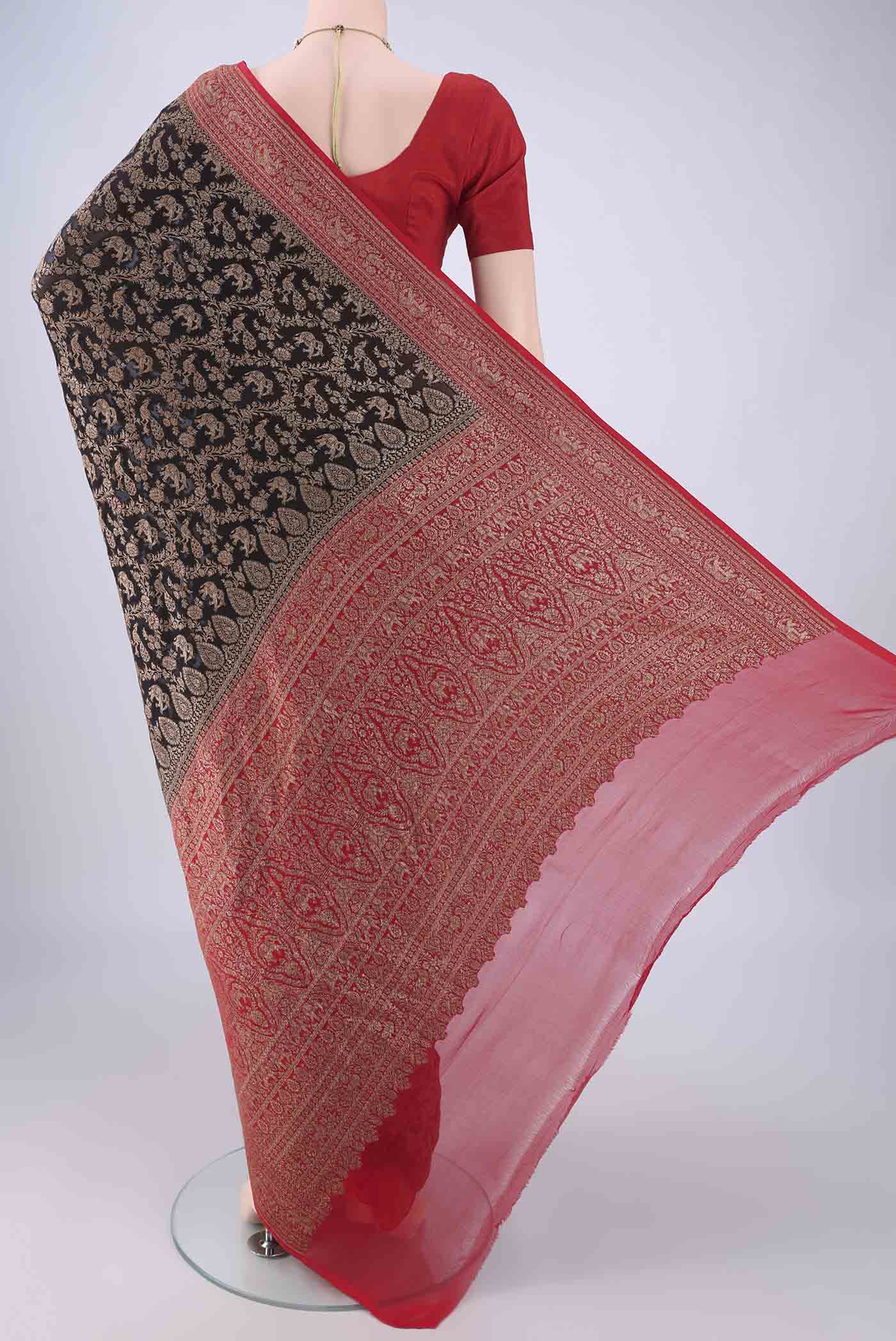 Flat view of Black Banarasi Georgette Saree with Zari Brocade on the body and Zari Border. 