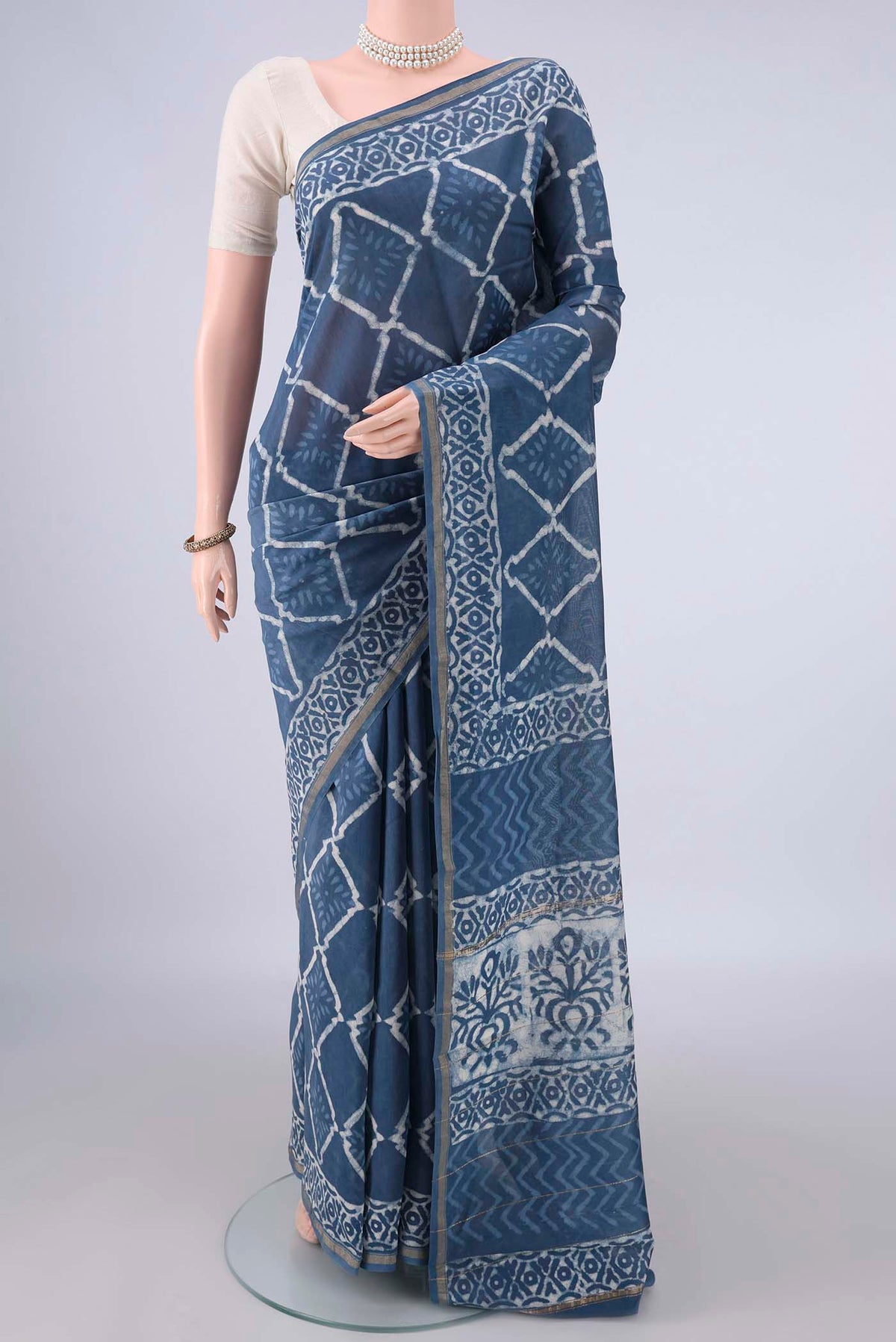 Blue Grey Chanderi Cotton Saree with Batik Print on the body and Thin Zari Line.  displayed on a mannequin