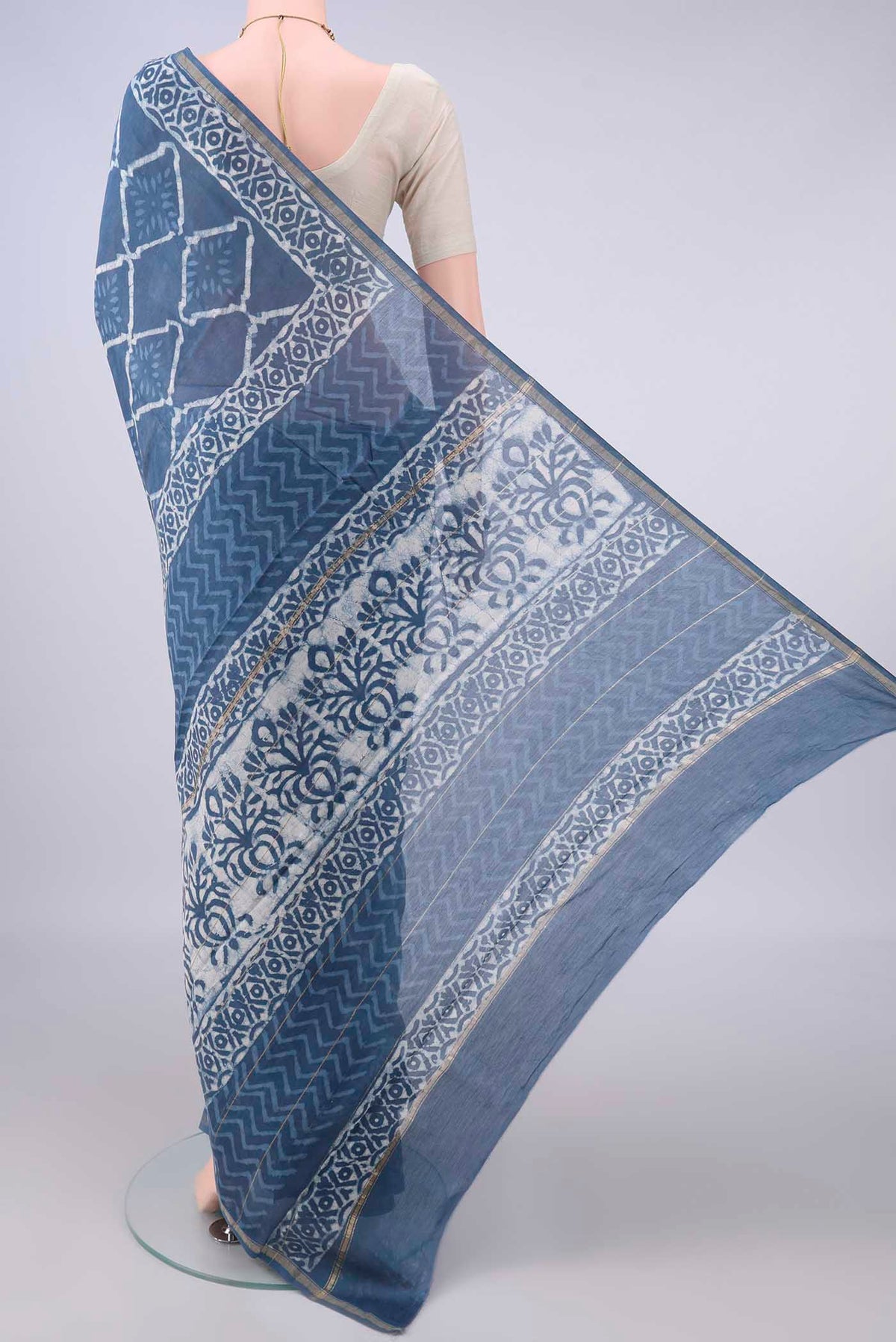 Flat view of Blue Grey Chanderi Cotton Saree with Batik Print on the body and Thin Zari Line. 