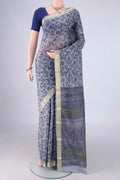 Grey Printed Silk Saree with Printed design on the body and Zari Border.  displayed on a mannequin