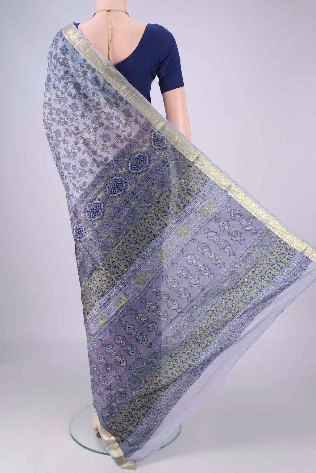 Flat view of Grey Printed Silk Saree with Printed design on the body and Zari Border. 