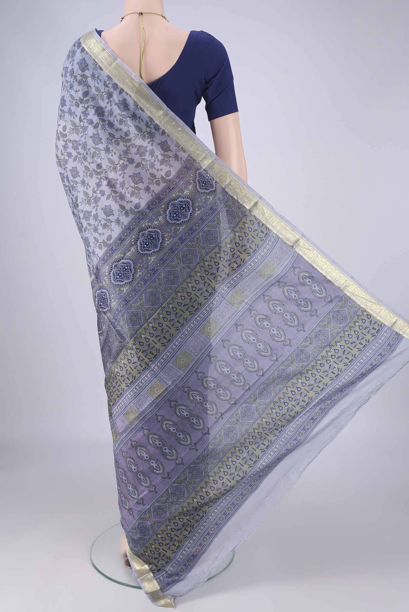 Flat view of Grey Printed Silk Saree with Printed design on the body and Zari Border. 