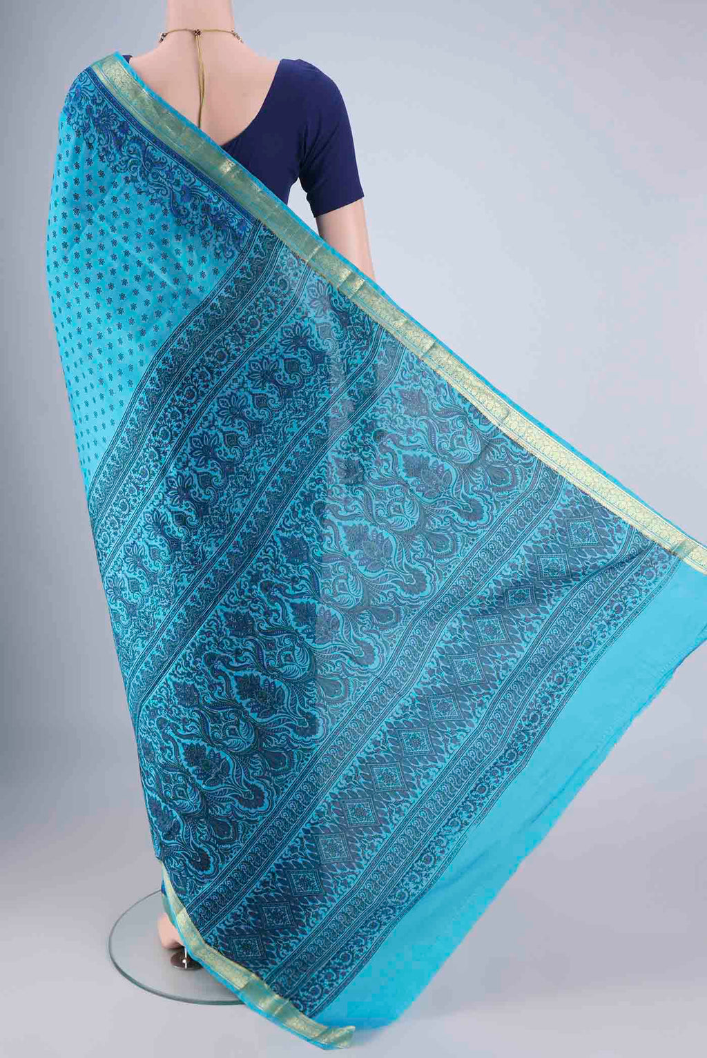 Flat view of Blue Printed Silk Saree with Printed design on the body and Zari Border. 