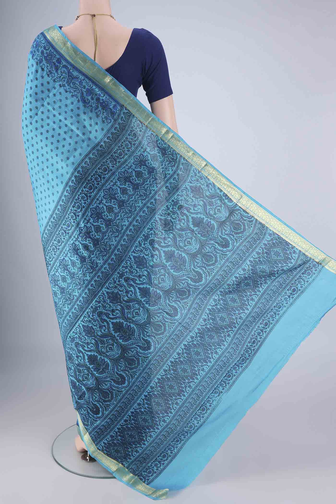 Flat view of Blue Printed Silk Saree with Printed design on the body and Zari Border. 