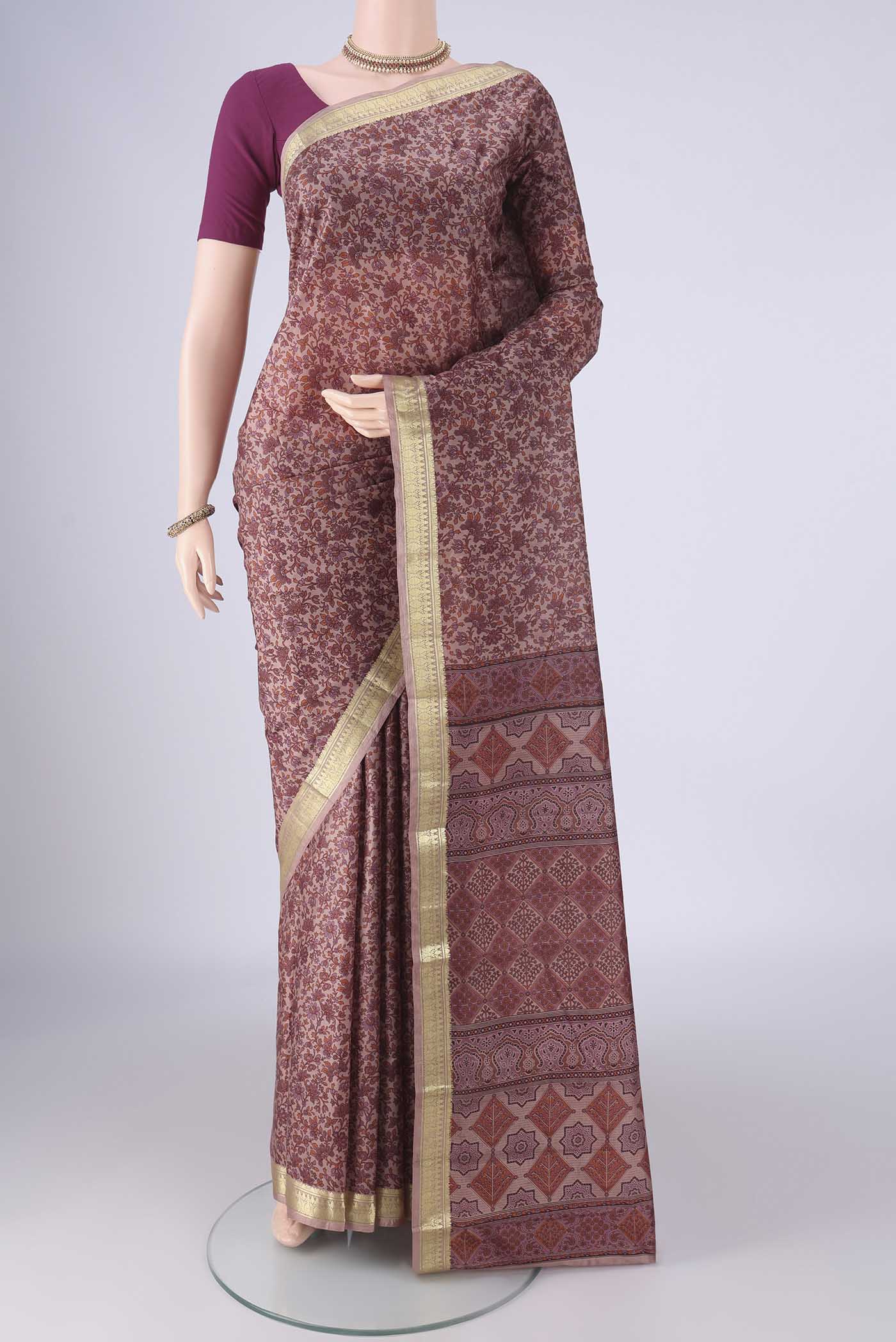 Mauve Printed Silk Saree with Printed design on the body and Zari Border.  displayed on a mannequin