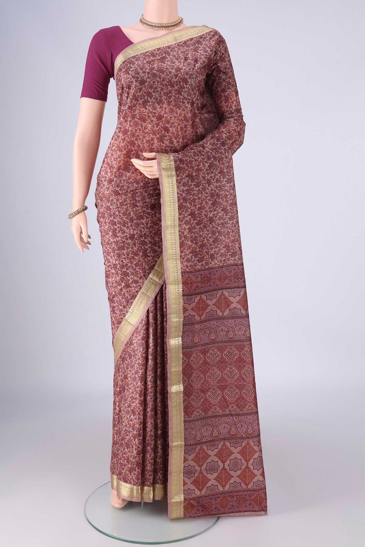 Mauve Printed Silk Saree with Printed design on the body and Zari Border.  displayed on a mannequin