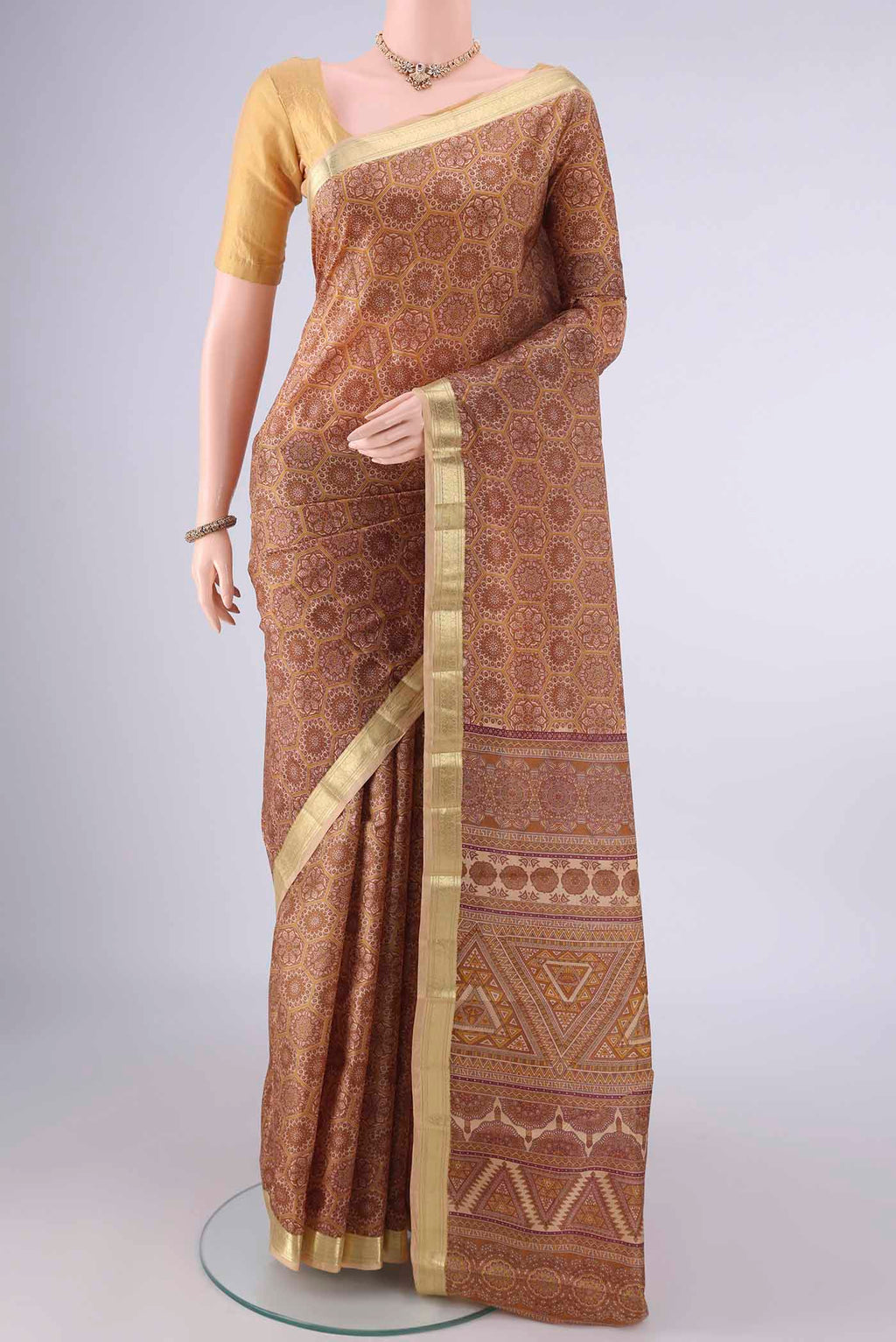 Pure Silk Brown Printed Saree with Printed design on the body and Zari Border.  displayed on a mannequin