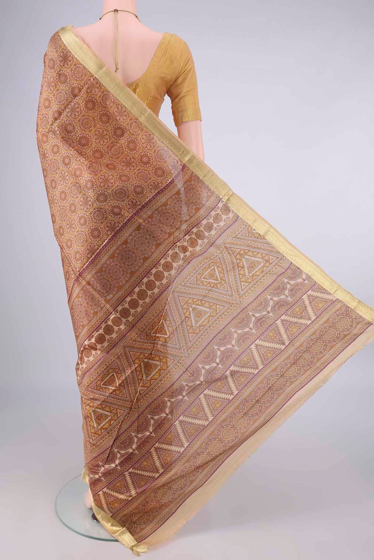 Flat view of Pure Silk Brown Printed Saree with Printed design on the body and Zari Border. 