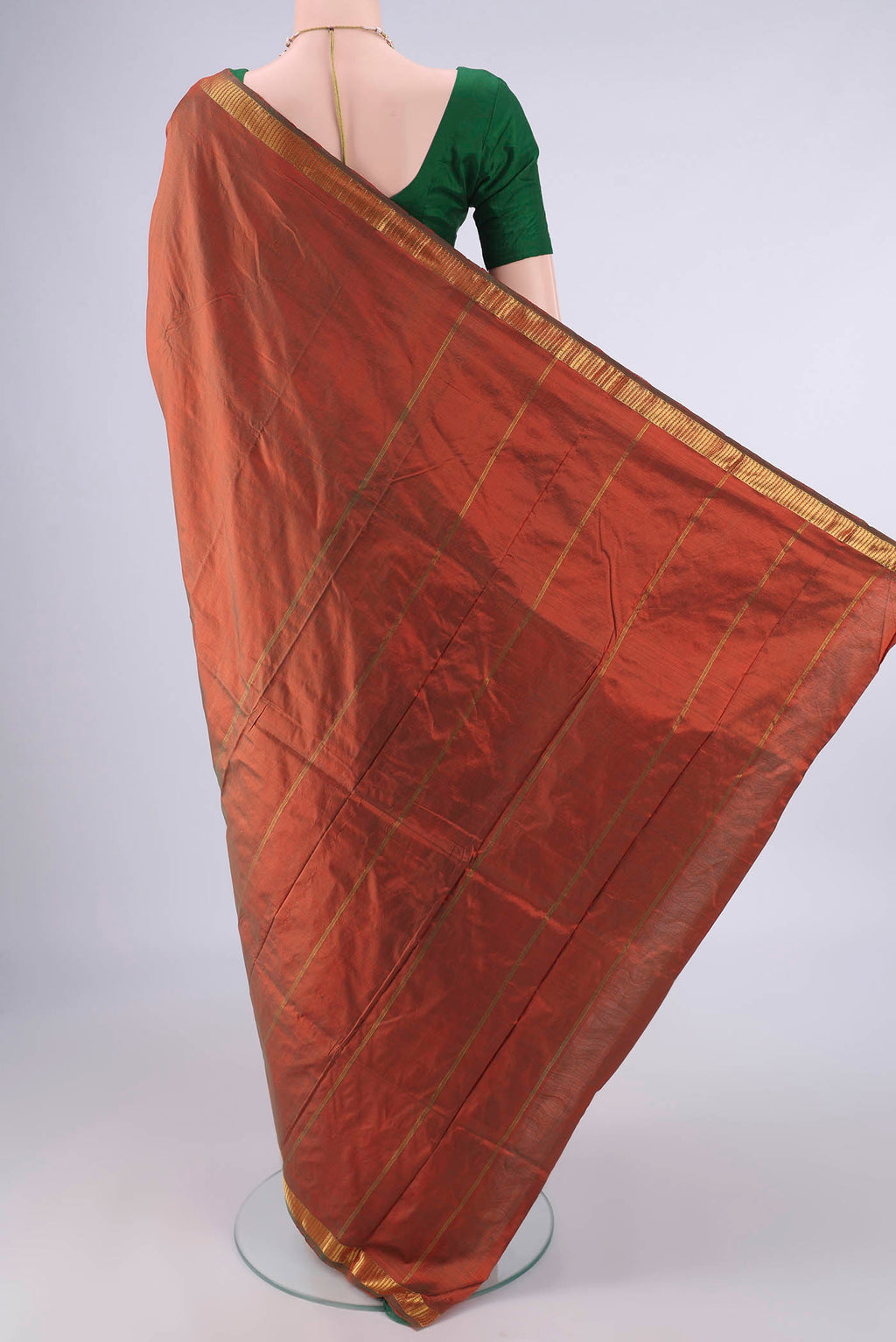Flat view of Pure Silk Rust Dual Tone Kanchipuram Saree with Plain Body and Zari Border. 