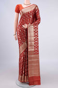 Rust Banarasi Tussar Saree with Zari And Thread Butta on the body and Zari Border.  displayed on a mannequin