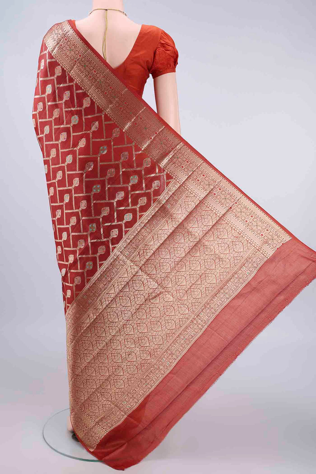 Flat view of Rust Banarasi Tussar Saree with Zari And Thread Butta on the body and Zari Border. 