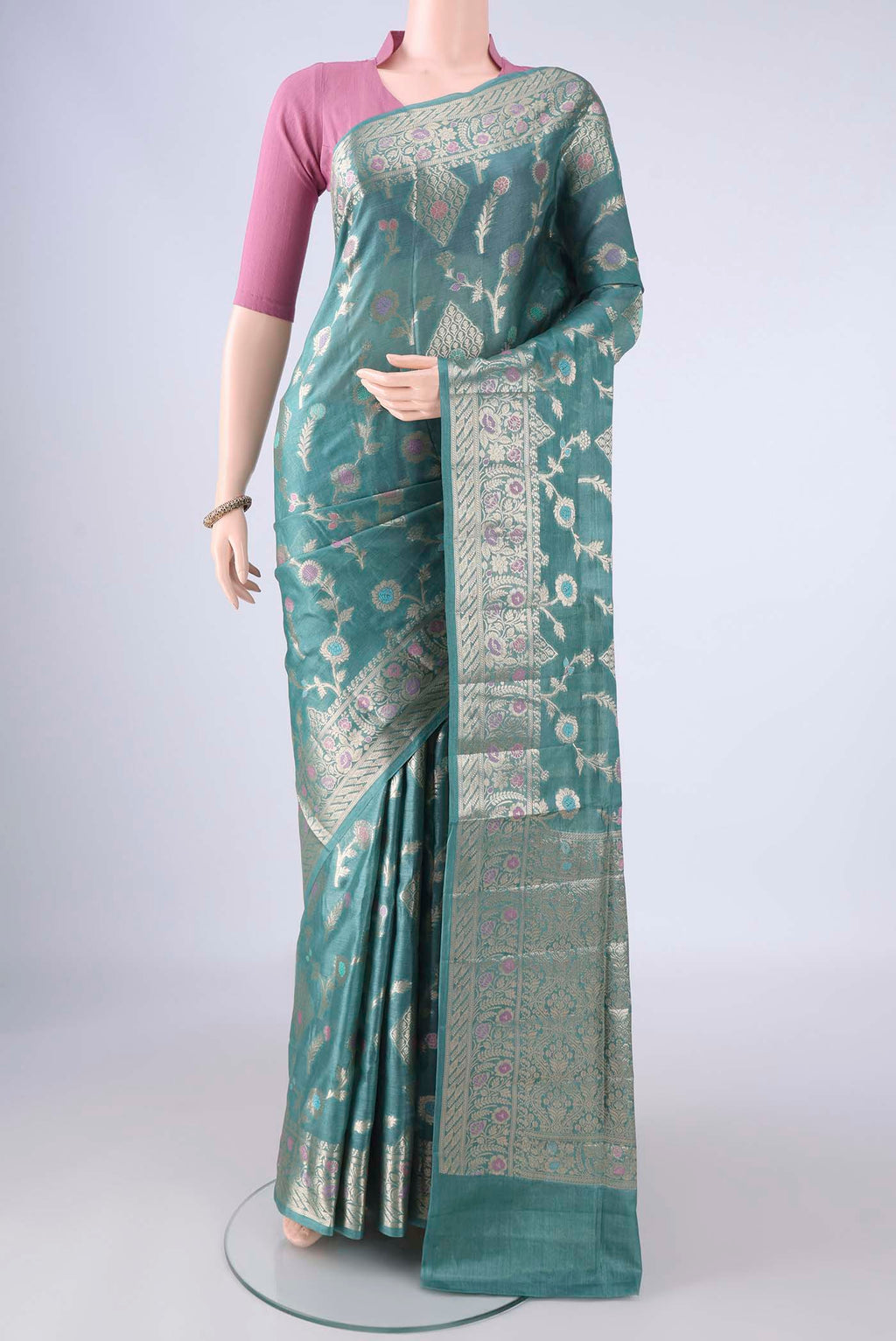 Light Blue Banarasi Tussar Silk Saree with Zari And Thread Butta on the body and Zari Border.  displayed on a mannequin