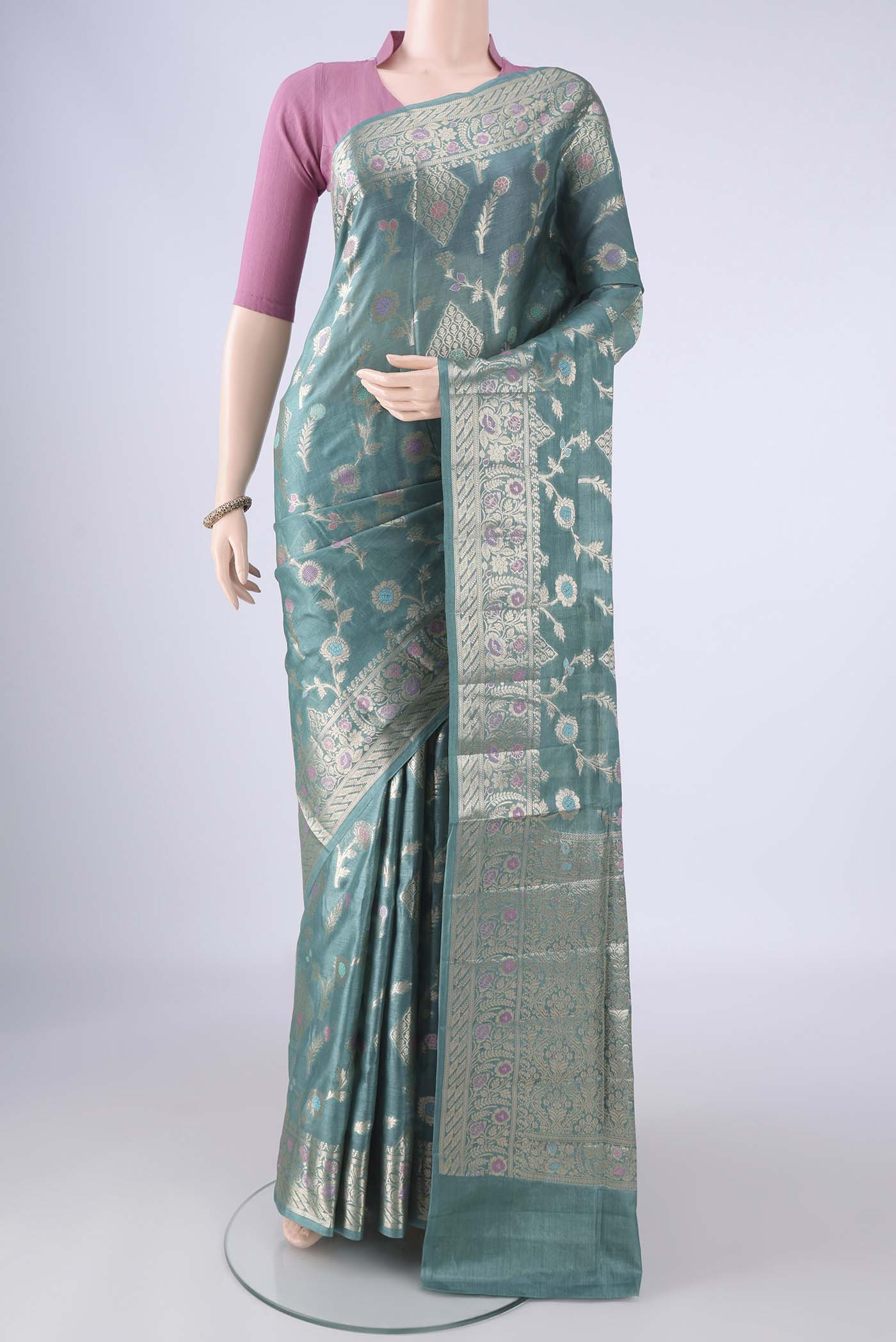 Light Blue Banarasi Tussar Silk Saree with Zari And Thread Butta on the body and Zari Border.  displayed on a mannequin