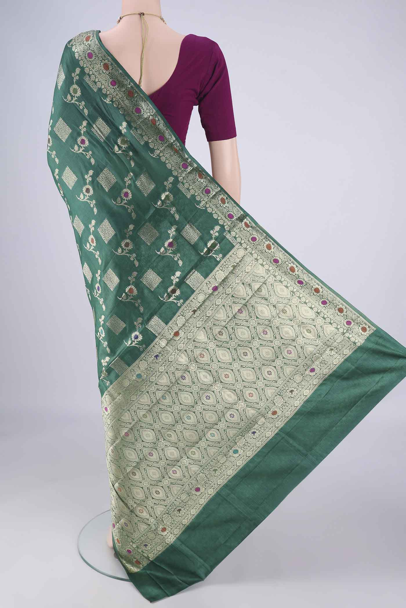 Flat view of Green Banarasi Tussar Silk Saree with Zari Brocade on the body and Zari Border. 
