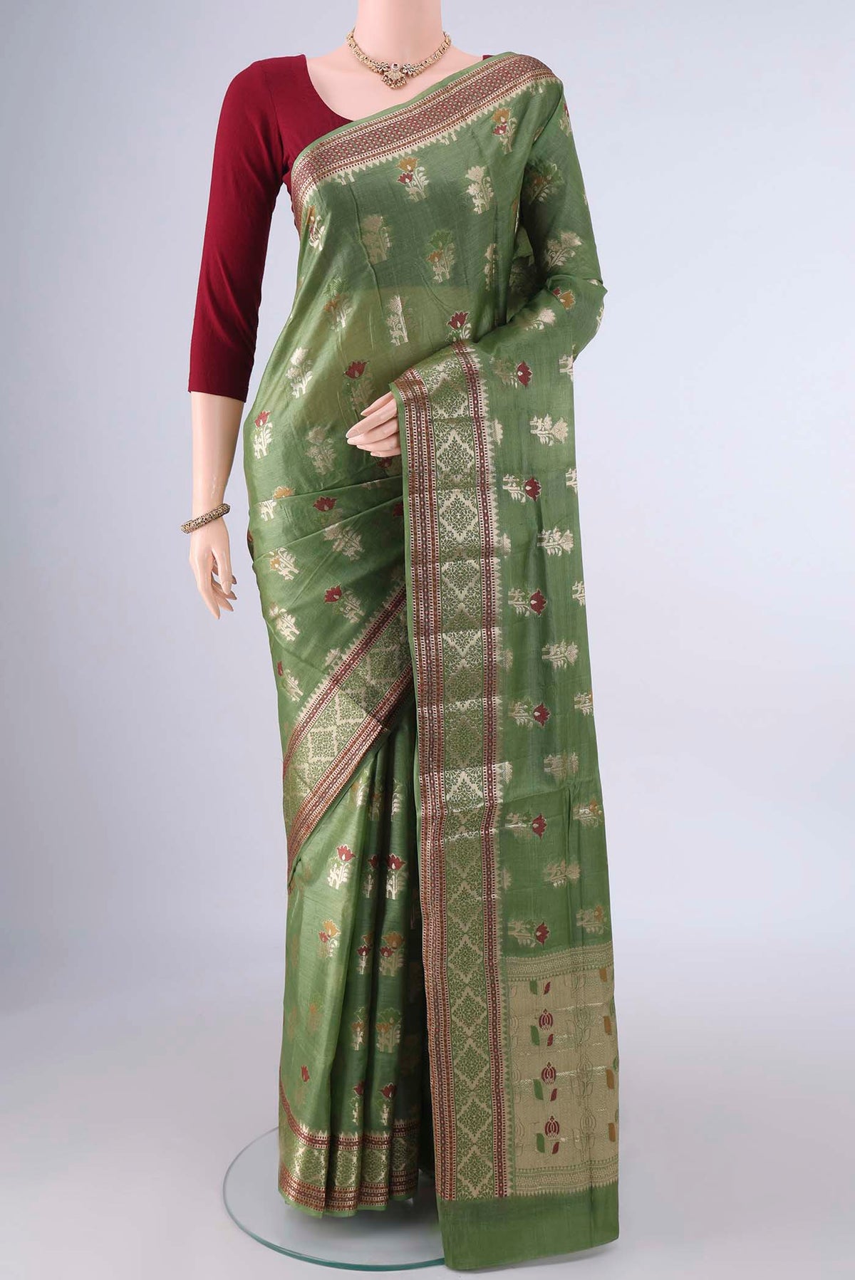 Olive Green Banarasi Tussar Saree with Zari And Thread Butta on the body and Zari And Thread Border.  displayed on a mannequin