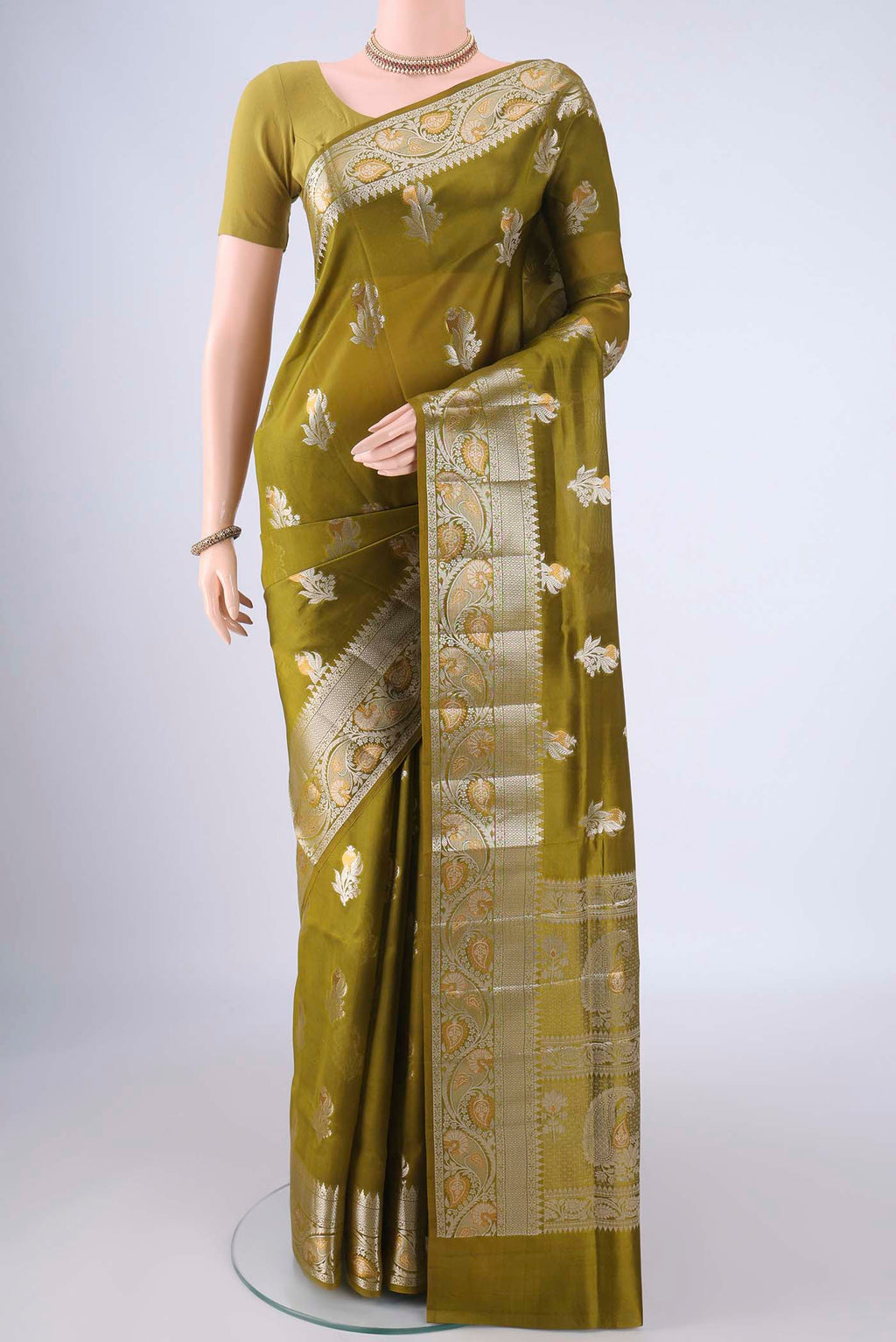 Mehandi Green Banarasi Raw Silk Saree with Zari Butta on the body and Zari Border.  displayed on a mannequin