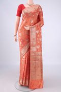 Peach Banarasi Raw Silk Saree with Zari And Thread Butta on the body and Zari Border.  displayed on a mannequin
